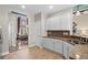 This kitchen has tile floors, white cabinets, granite countertops, stainless sink, and a dining area view at 950 Henry James Dr., Myrtle Beach, SC 29579