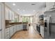 Well-lit kitchen with stainless steel appliances, tile floors, granite countertops, and adjacent dining area at 950 Henry James Dr., Myrtle Beach, SC 29579
