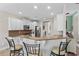 This kitchen features white cabinetry, stainless appliances, a breakfast bar with seating, and granite countertops at 950 Henry James Dr., Myrtle Beach, SC 29579