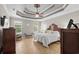 The main bedroom has a decorative trey ceiling, ceiling fan and light hardwood floors at 950 Henry James Dr., Myrtle Beach, SC 29579