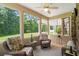 This is the screened porch featuring wicker chairs, ceiling fan and outdoor views of the backyard at 950 Henry James Dr., Myrtle Beach, SC 29579