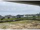 View of backyard pond and neighboring houses from a new construction home at 977 Oak Hollow St., Longs, SC 29568