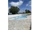 Community pool featuring a light brick surround, multiple ladders, and palm trees at 977 Oak Hollow St., Longs, SC 29568