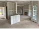 Spacious open-concept living room with a fireplace and large windows at 977 Oak Hollow St., Longs, SC 29568