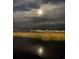 Night landscape of water and distant buildings with a full moon behind clouds at 977 Oak Hollow St., Longs, SC 29568