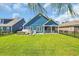 Spacious backyard with lush green grass, privacy fence, and screened-in porch at 1012 Mary Read Dr., North Myrtle Beach, SC 29582