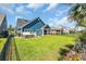 Backyard featuring a manicured lawn, spa, and privacy fence, creating a serene outdoor space at 1012 Mary Read Dr., North Myrtle Beach, SC 29582