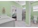 Well-appointed bathroom featuring double sinks, glass shower, and open doorway to bedroom at 1012 Mary Read Dr., North Myrtle Beach, SC 29582