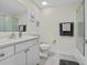 Bathroom featuring a single sink vanity, light walls, a tiled shower, and gray ceramic tile floors at 1012 Mary Read Dr., North Myrtle Beach, SC 29582