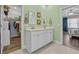 Bathroom with dual sink vanity and doorway to bedroom with walk-in closet and open shower at 1012 Mary Read Dr., North Myrtle Beach, SC 29582