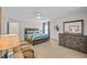 Cozy bedroom with ceiling fan, comfy chair, and dresser with decorative mirror at 1012 Mary Read Dr., North Myrtle Beach, SC 29582