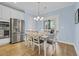 A cozy dining area features a table for six, stainless steel fridge, and a sliding glass door to the outside at 1012 Mary Read Dr., North Myrtle Beach, SC 29582