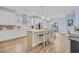 Spacious kitchen with white cabinets, a kitchen island with bar stool seating, and stainless steel appliances at 1012 Mary Read Dr., North Myrtle Beach, SC 29582