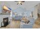 Cozy living room features a vaulted ceiling, fireplace with stone surround, and lots of comfortable seating at 1012 Mary Read Dr., North Myrtle Beach, SC 29582
