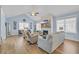 Spacious living room with a fireplace, light blue walls, lots of seating, and gleaming hardwood floors at 1012 Mary Read Dr., North Myrtle Beach, SC 29582