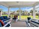 Cozy screened patio featuring stylish furniture and a beautiful view of the landscaped backyard at 1012 Mary Read Dr., North Myrtle Beach, SC 29582