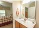Bathroom vanity featuring a large mirror and sink, with a bedroom view at 1028 Fairway Ln. # 71, Conway, SC 29526
