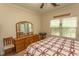 Light filled bedroom with ensuite and dresser with mirror at 1028 Fairway Ln. # 71, Conway, SC 29526