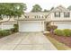 Street view of townhouses featuring attached garages and mature landscaping at 1028 Fairway Ln. # 71, Conway, SC 29526
