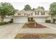 Townhouse-style homes with attached garages and well-maintained landscaping at 1028 Fairway Ln. # 71, Conway, SC 29526