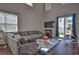 Spacious living room with hardwood floors, high ceilings, sliding glass door, and large gray couch at 1029 Tee Shot Dr. # 1029, Conway, SC 29526