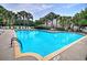 Outdoor swimming pool surrounded by palm trees and lounge chairs at 1029 Tee Shot Dr. # 1029, Conway, SC 29526