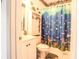 Small bathroom featuring a custom painted shower curtain, linen cabinet and a white vanity at 1058 Sea Mountain Hwy. # 3-201, North Myrtle Beach, SC 29582