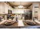 Well-lit kitchen featuring tiled floors, stainless steel appliances, and a breakfast bar at 1058 Sea Mountain Hwy. # 3-201, North Myrtle Beach, SC 29582