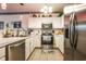 Cozy kitchen featuring stainless steel appliances, granite countertops, and tile flooring at 1058 Sea Mountain Hwy. # 3-201, North Myrtle Beach, SC 29582