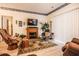 Cozy living room featuring fireplace, tile floor, and natural lighting at 1058 Sea Mountain Hwy. # 3-201, North Myrtle Beach, SC 29582