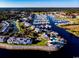 Picturesque aerial shot of a marina with boats and buildings nestled by the water and lush landscape at 1106 Tarpon Pond Rd., North Myrtle Beach, SC 29582