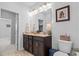 Bathroom featuring granite counters, dark cabinets, tile flooring, linen closet and modern fixtures at 1106 Tarpon Pond Rd., North Myrtle Beach, SC 29582