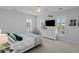 Bright bedroom features a ceiling fan, television, and two windows with white shutters at 1106 Tarpon Pond Rd., North Myrtle Beach, SC 29582
