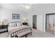 A bright bedroom with neutral walls, ceiling fan, carpeted floors and comfortable bed at 1106 Tarpon Pond Rd., North Myrtle Beach, SC 29582
