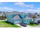 Charming two-story home with a gray roof, a two-car garage, and a well-manicured front lawn at 1106 Tarpon Pond Rd., North Myrtle Beach, SC 29582