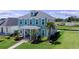 Charming blue two-story home with landscaped yard and inviting porch at 1106 Tarpon Pond Rd., North Myrtle Beach, SC 29582