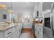 Well-lit kitchen showcasing stainless steel appliances, granite countertops, and a farmhouse sink at 1106 Tarpon Pond Rd., North Myrtle Beach, SC 29582