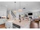 Bright, open kitchen with stainless appliances and large island open to a dining and living area at 1106 Tarpon Pond Rd., North Myrtle Beach, SC 29582