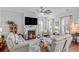 Cozy living room with fireplace, plush seating, large windows, and stylish decor at 1106 Tarpon Pond Rd., North Myrtle Beach, SC 29582