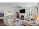 Bright living room featuring a fireplace, comfortable seating, and a ceiling fan for added comfort at 1106 Tarpon Pond Rd., North Myrtle Beach, SC 29582