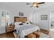 A bright main bedroom featuring neutral walls, wood flooring, a ceiling fan and comfortable bedding at 1106 Tarpon Pond Rd., North Myrtle Beach, SC 29582