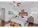 Comfortable main bedroom with light-colored walls, area rug, ceiling fan and beautiful furnishings at 1106 Tarpon Pond Rd., North Myrtle Beach, SC 29582
