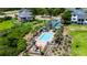 Aerial view of a community pool and sunbathing area, surrounded by palm trees and landscaping at 1106 Tarpon Pond Rd., North Myrtle Beach, SC 29582