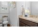 Charming powder room featuring granite vanity and a window with white shutters at 1106 Tarpon Pond Rd., North Myrtle Beach, SC 29582