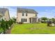 Spacious backyard featuring a well-manicured lawn, patio area, and black metal fence surrounding the property at 1189 Wyatt Ln., Myrtle Beach, SC 29577