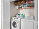 Bright laundry room with front-load washer, dryer, wire shelving, and plenty of storage for laundry and beach accessories at 1189 Wyatt Ln., Myrtle Beach, SC 29577