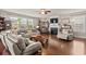 Cozy living room featuring a fireplace, hardwood floors, and ample natural light with designer touches at 1189 Wyatt Ln., Myrtle Beach, SC 29577