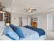 Bright main bedroom featuring a ceiling fan, white trim, and a large comfy bed with blue accent pillows at 1189 Wyatt Ln., Myrtle Beach, SC 29577