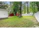 Backyard features mature trees, a lush lawn, privacy fence, and an outdoor storage shed at 1205 King St., Myrtle Beach, SC 29577
