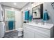 A light and bright bathroom featuring a vanity, toilet, and washer and dryer at 1205 King St., Myrtle Beach, SC 29577